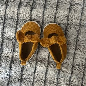 Yellow corduroy baby booties with bow